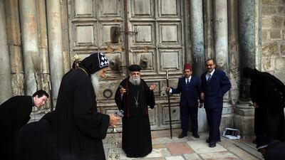 Coptic priests hold a mass outside a closed Church of the Holy Sepulchre, in Jerusalem, on March 28, 2020. AP Photo