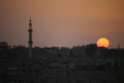 The sun setting over a rebel-held area in the southern Syrian city of Daraa on April 20, 2018. Mohamad Abazeed / AFP