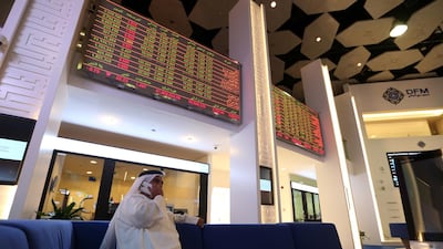 Traders gather at the Dubai Financial Market. Eighty per cent of UAE investors are bullish on local stocks. EPA