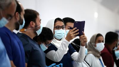 Medics see off Dubai Parks and Resorts field hospital's last 17 coronavirus patients. Chris Whiteoak / The National