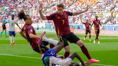 France's Marcus Thuram tangles with Belgium's Kevin De Bruyne and Arthur Theate. AP