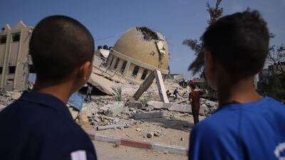 People at the site of a destroyed mosque following an Israeli air strike in Khan Younis, Gaza Strip, on Sunday. Bloomberg