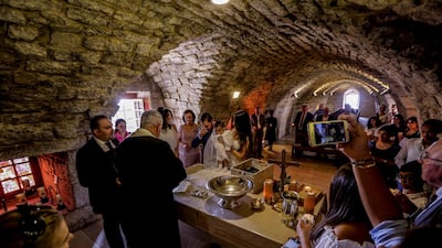 A priest prays during the ceremony of the baptism of a child at Saint Charbel Makhlouf monastery at Annaya village, Jbeil District, northern Lebanon. EPA