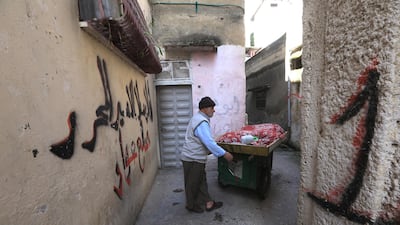 A Palestinian vendor sells vegetables in Balata refugee camp near the West Bank city of Qalqilya. EPA