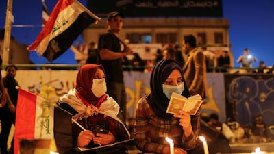 Demonstrators read Quran and light up candles for the people killed at an anti-government protest in Iraq, in Baghdad. REUTERS