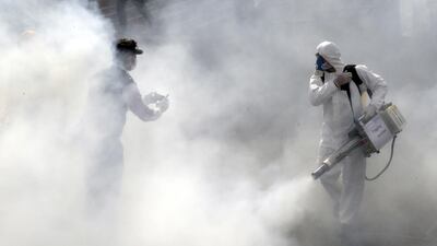 Firefighters disinfect streets in an effort to halt the spread of coronavirus in Tehran, March 13. EPA