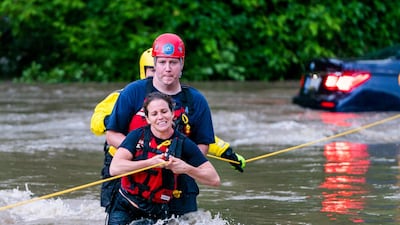 Commuters are rescued from a flooded car on Columbia Pike after a flash flood in Oakland Mills, Maryland, USA, 27 May 2018. The National Weather Service stated as much as 9.5 inches of rain fell in the area. Jim Lo Scalzo / EPA