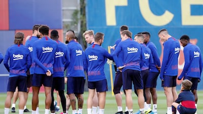 Luis Suarez's son Benjamin, right, listens in on team tactics at Barcelona training. EPA