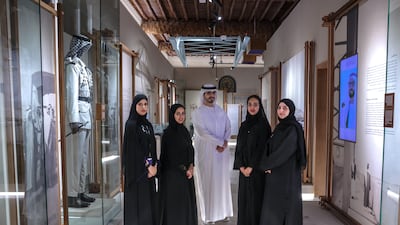 Al Maqta'a Museum head, Abdulaziz Naser Almansoori, middle, with his staff, from left to right, Mariam Al Hamadi, Hamda Al Mansoori, Mariam Al Zaabi and Amena Al Marzooqi