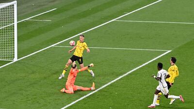 Vinicius Junior scores Real Madrid's second goal past Dortmund goalkeeper Gregor Kobel. AFP