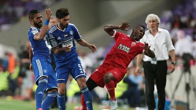 Al Nasr’s Tariq Ahmed (5) body checks Al Ahli’s Ismail Al Hammadi during the President’s Cup final match at Hazza bin Zayed Stadium in Al Ain on June 3, 2015. Also pictured is Al Nasr’s Ahmed Ibrahim, left. Christopher Pike / The National