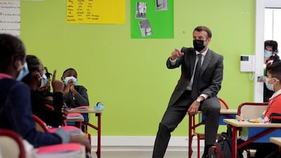 French President Emmanuel Macron addresses pupils during a visit to a primary school in Melun, as French primary schools and kindergartens reopen after three-week closure amid the Covid-19 pandemic. AFP