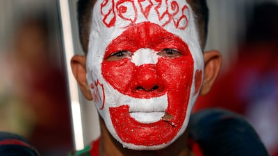 A member of Thailand's Pheu Thai Party with his face painted with the electoral number and name of the party's lead candidate for prime minister, Yodchanan Wongsawat, during a rally in Bangkok. EPA