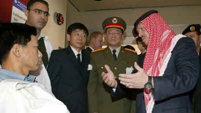 King Abdullah visits a wounded Chinese citizen at a hospital in Amman in November 2005. Three Chinese were killed and one wounded in suicide attacks in the city. AFP