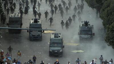 Protesters run from riot police during clashes at Tahrir square in Cairo on November 23, 2012. Egyptian President Mohammed Morsi's decree that put his decisions above legal challenge until a new parliament was elected caused fury amongst his opponents who accused him of being the new Hosni Mubarak and hijacking the revolution. Mohamed Abd El Ghany / Reuters