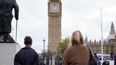 Members of the public observe a two-minute silence in Parliament Square, London. PA