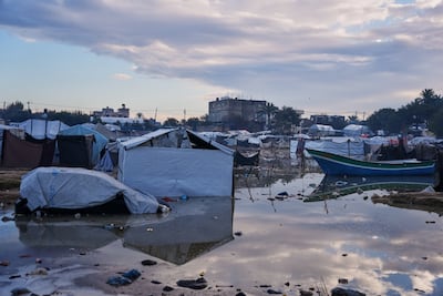 A car is partially submerged in floodwater after heavy rain at a camp for displaced Palestinians in Zawaida, central Gaza. AP Photo