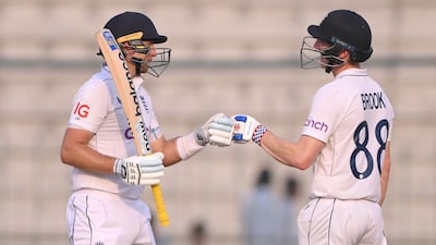 England batsman Harry Brook, right, congratulates Joe Root for reaching 150 at the Multan Cricket Stadium. Getty Images