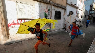 Palestinian children play in a street in the Amari refugee camp near the West Bank city of Ramallah. AFP