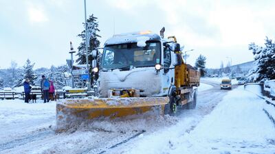 A snow plough clears a road in Carrbridge, Scotland. Reuters