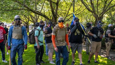 Proud Boys and other right-wing demonstrators pursue counter-protesters after a pro-Trump caravan rally at the Oregon State Capitol building on September 7, 2020. Getty Images / AFP