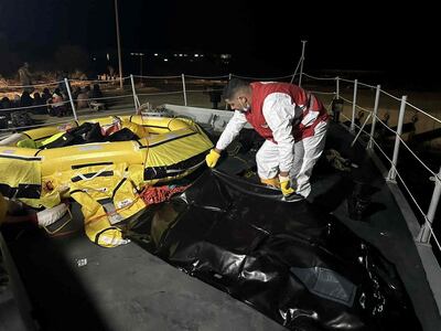 A Red Crescent worker moves a body bag after two boats carrying migrants capsized off the Libyan coastal city of Al Khums. Reuters