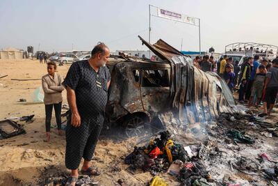 Palestinians gather at the site of an Israeli strike on a camp area housing displaced people in Rafah. AFP