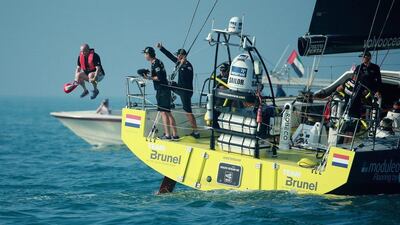 A Team Brunel guest jumps off the boat as they depart for the open ocean during the Volvo Ocean Race's Leg 3 start on Saturday from Abu Dhabi to Sanya, China. Photo Courtesy / Volvo Ocean Race / Getty Images
