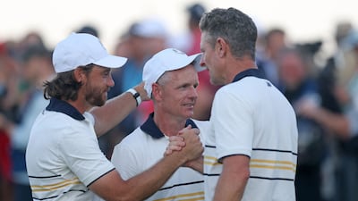 Tommy Fleetwood, left, captain Luke Donald and Justin Rose of Team Europe celebrate. AFP