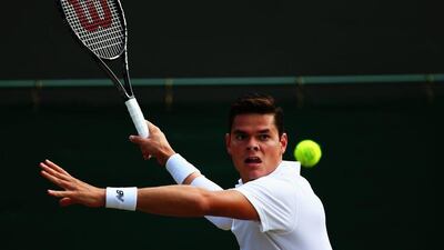 Milos Raonic returns a shot against Kei Nishikori on Tuesday in their Wimbledon fourth-round match at the All England Club in London, England. Clive Brunskill / Getty Images / July 1, 2014
