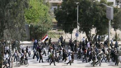 Anti-government protesters march during a demonstration following Friday prayers near Damascus on April 22.