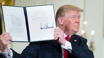 US President Donald Trump holds up a policy directive he signed during a meeting of the National Space Council on June 18, 2018. Michael Reynolds / EPA
