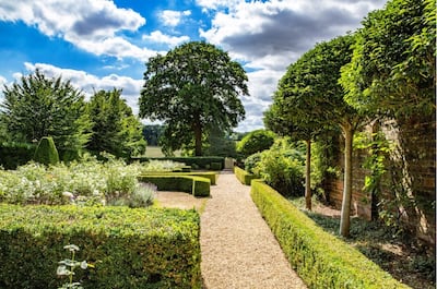 The landscaped gardens and walkways feature a rose and wisteria walk, as well as a rose garden, swimming pool and tennis court. Photo: Knight Frank and Savills