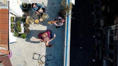 An aerial view of the performance of dancer Su Sevda Uzun from a terrace of her friend's home while she is accompanied by musicians Hakan Kaya and Alper Kalayciklioglu, in Istanbul, Turkey. Reuters