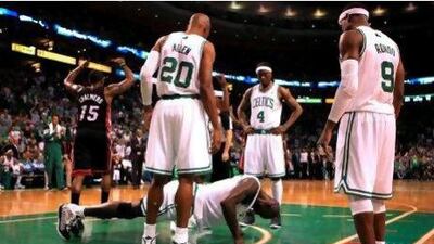 As his Boston Celtics teammates look on Kevin Garnett does pushups after being knocked down by the Miami Heat's Udonis Haslem in the first half.