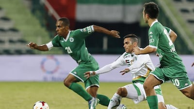 Al Shabab’s Adel Abdullah, left, avoids a tackle while his teammate Carlos Villanueva looks on during their match against Emirates on Friday night. Al Ittihad