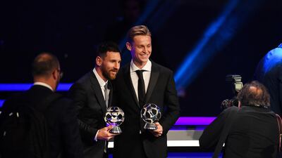 Barcelona's Messi and De Jong with their respective trophies. EPA