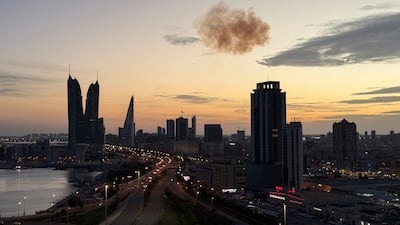 Smoke rises after an Iranian drone is intercepted on Friday over the Bahrain Financial Harbour towers, which houses the Israeli embassy, in Manama. Reuters
