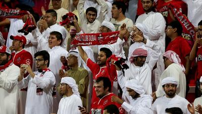 Al Ahli fans celebrate after their club's victory on Sunday. Satish Kumar / The National