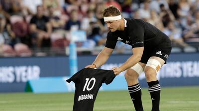 New Zealand captain Sam Cane lays an All Black No 10 jersey on the pitch in memory of late Argentina football star Diego Maradona. AP