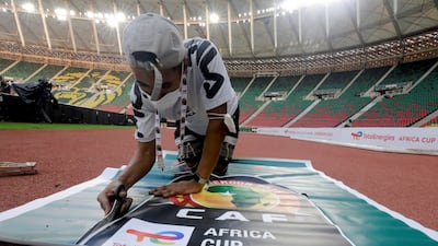 A worker prepares banners at the Olembe Stadium, which is hosting the opening ceremony of the Africa Cup of Nations. Reuters