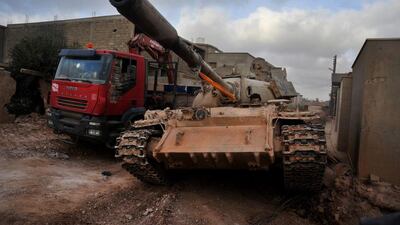 A fighter loyal to Tobruk sits in a tank during clashes with ISIL militants west of Benghazi, Libya, in March. Mohammed El Shaiky, File/AP Photo