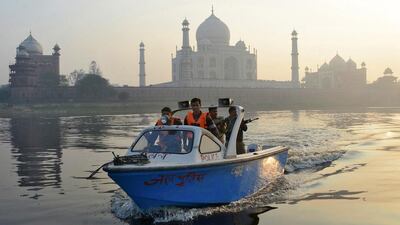 Police patrol in a boat on the waters of the river Yamuna behind the historic Taj Mahal in the northern Indian city of Agra on January 18, 2015. US President Barack Obama is scheduled to visit the Taj Mahal on January 27 during his visit to India. Brijesh Singh/Reuters