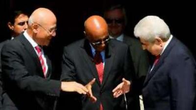 Right to left, Demetris Christofias, the Greek Cypriot president, Taye-Brook Zerihoun, the UN special representative to Cyprus, and Mehmet Ali Talat, the Turkish Cypriot leader, shake hands after their meeting at a UN compound in the divided capital of Nicosia.