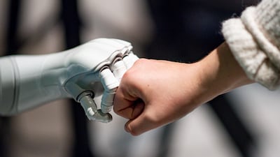 A robot interacts with a woman at 'Speed Dating with AI - Meet the Robots at AI Days' at the Hammerbrooklyn Digital Campus in Germany. Photo: Axel Heimken / Getty