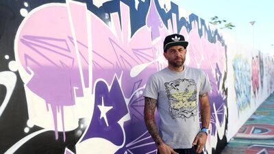 Street artist Sya One at his graffiti wall in his garden. Satish Kumar / The National