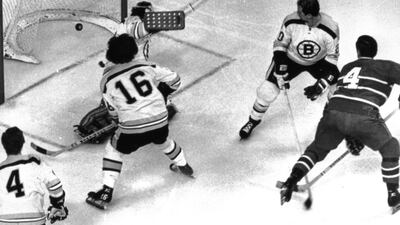 Left to right, Bobby Orr, Derek Sanderson and Dallas Smith are helpless as Jean Beliveau puts a backhander past Ed Johnston to bring the Montreal Canadiens to within a goal of the Boston Bruins during an epic comeback on April 8, 1971. Bruce Bennett Studios / Getty Images
