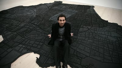 The Lebanese artist Marwan Rechmaoui with his work Beirut Caoutchouc, a map of Beirut consisting of 60 interlocking pieces of rubber. Shaun Curry / AFP