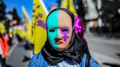 A woman wears a mask as she takes part in a march in Istanbul ahead of the International Women’s Day on March 8. Bulent Kilic / AFP Photo