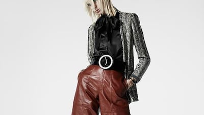 Leather culottes reminiscent of the 1970s and a black satin pussy-bow blouse are updated with an oversized belt and a fitted skinny jacket. Courtesy Saint Laurent